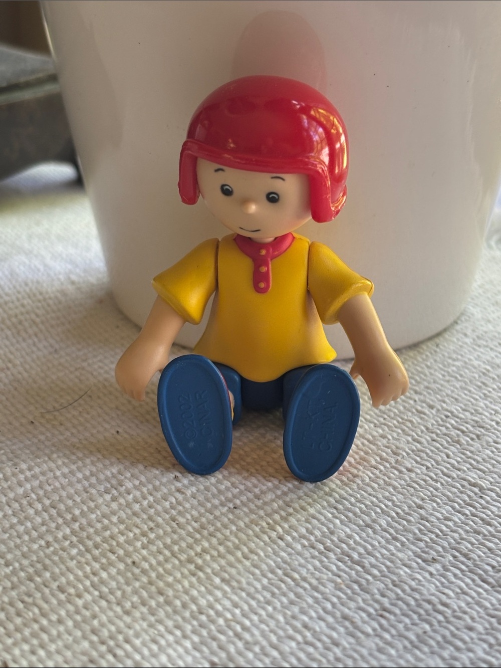 Caillou action figure featuring a yellow shirt & red helmet. 2002 CINAR PBS kids